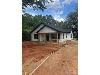 Charming new construction with white siding, black roof, and inviting front porch at 807 S Bostian St, China Grove, NC 28023