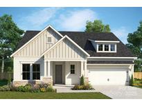 Charming craftsman-style home featuring vertical siding, stone accents and a two-car garage at 1015 Idyllic Ln, Waxhaw, NC 28173