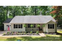Charming single-story home with a welcoming porch and a well-manicured front yard at 109 Pepper Cir, Mooresville, NC 28117