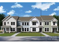 A row of newly constructed townhomes with varied color schemes, creating a vibrant street view at 11459 Prosperity Church Rd, Huntersville, NC 28078