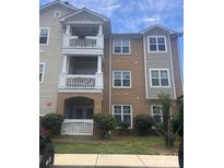 Charming condo with brick and siding, featuring inviting balconies and well-maintained landscaping at 11863 Ridgeway Park Dr, Charlotte, NC 28277