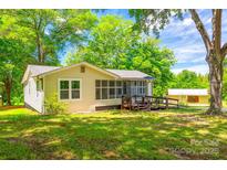 Charming home featuring a well-manicured lawn and welcoming wooden ramp for accessibility at 1224 Martin Rd, Hickory Grove, SC 29717