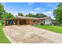Charming single-story home with a covered carport and beautifully landscaped front yard at 141 Porter Rd, Statesville, NC 28625