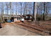 Charming brick home featuring a carport, mature trees, and a classic design in a quiet neighborhood at 170 Heritage Ln, Salisbury, NC 28147
