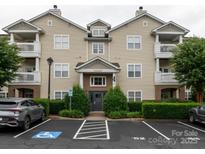 Inviting exterior of the home featuring manicured landscaping and ample parking spaces at 17119 Doe Valley Ct, Cornelius, NC 28031