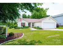 Charming single-story home featuring a well-manicured lawn and attached two car garage at 1957 8Th Street Se Ln, Hickory, NC 28602