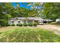 Charming single-story home with mature trees and well-kept lawn at 208 Lipe Rd, Troutman, NC 28166