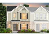 Charming two-story townhome with a brick facade, neutral siding, and manicured landscaping at 2119 Riverstone Blvd # 141, Monroe, NC 28110