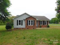 Charming home featuring a brick facade, black shutters, and a well-maintained lawn at 3001 Austin Chaney Rd, Monroe, NC 28110