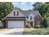 Charming two-story home with brick and siding, red shutters, and attached garage at 3428 Cranberry Nook Ct, Charlotte, NC 28269