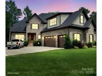 Beautiful brick home featuring an attached two-car garage, well-maintained lawn, and traditional architectural style at 4143 Willow Haven Dr, Denver, NC 28037