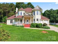 Inviting two-story home featuring a charming front porch and well-maintained landscaping at 4499 Briarcreek Rd, Maiden, NC 28650