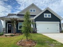 Charming new construction home featuring dark siding, stone accents, and a convenient two-car garage at 108 Red Juniper Way, Statesville, NC 28625