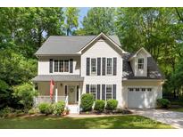 Charming two-story home boasts lush landscaping and a welcoming front porch at 116 Oak Creek Dr, Charlotte, NC 28270