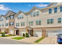 Charming townhouse complex featuring beige siding, brick accents, and well-manicured lawns in a desirable neighborhood at 117 Langhorne Dr, Mount Holly, NC 28120