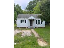 Exterior view of a one-story home with a gravel driveway and black shutters at 134 S Jackson Rd, Lancaster, SC 29720