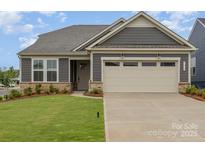 Charming single-Gathering home with a manicured lawn, neutral siding, and an attached two car garage at 1818 Winding Mist Dr, Belmont, NC 28012