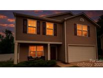Charming two-story home with brown siding, a two car garage, and a cozy front porch with warm lighting at 2021 Tarzi Ln, Charlotte, NC 28215