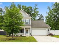 Charming two-story home with gray siding, a well-manicured lawn, and a two-car garage at 3053 Riker St, Clover, SC 29710
