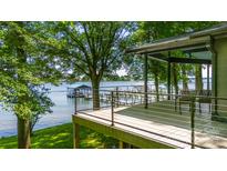Stunning lake view from the deck, featuring modern railings and ample seating space at 3248 Lake Shore S Rd, Denver, NC 28037