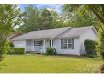 Charming single-story home with a well-maintained lawn, inviting porch, and attached garage at 3721 Conway Ave, Charlotte, NC 28209