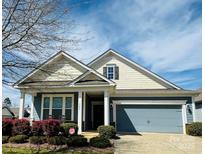 Charming single-Gathering home featuring a well-manicured lawn, covered porch, and attached two-car garage at 505 Belle Grove Dr, Lake Wylie, SC 29710