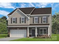 Charming two-story home featuring a two-car garage and classic architectural details at 5655 Arnold Way, Mount Pleasant, NC 28025