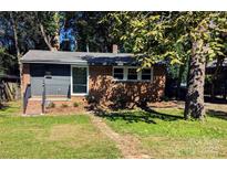 Charming brick home with a cozy front porch and well-maintained lawn at 631 Chipley Ave, Charlotte, NC 28205