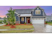 Charming single-Gathering home featuring a well-manicured lawn and a welcoming front porch at 705 Hinterland Ln, Matthews, NC 28104