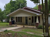 Charming single-story home with a welcoming front porch and well-maintained lawn at 804 Dennis St, Troy, NC 27371