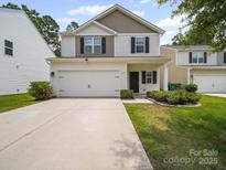 Charming two-story home featuring a large two-car garage, manicured lawn, and lovely curb appeal at 8314 Paw Valley Ln, Charlotte, NC 28214