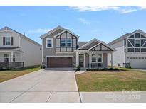 Charming two-story home featuring a well-manicured lawn and a covered front porch for relaxing at 9110 Buckley Ct # 154, Charlotte, NC 28269