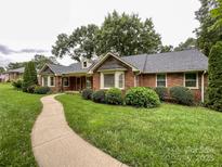 Charming brick home with a well-manicured lawn and winding walkway at 965 Hunting Ave, Lincolnton, NC 28092