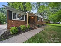 Charming brick home featuring manicured landscaping and inviting front entrance at 9818 Starwood Dr, Charlotte, NC 28215