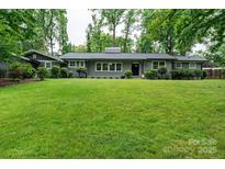 Charming brick home features a large lawn, updated windows, and mature landscaping at 1035 15Th Nw Ave, Hickory, NC 28601