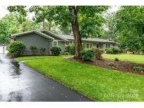 Charming single-story home featuring lush landscaping and a well-maintained front yard at 1035 15Th Nw Ave, Hickory, NC 28601