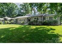 Charming single-story home with a manicured lawn and lush landscaping at 1035 15Th Nw Ave, Hickory, NC 28601