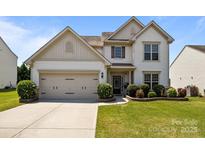 Charming two-story home with landscaped yard and an attached two-car garage at 1035 Ivey Ct, Indian Land, SC 29707