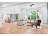 Spacious living room with an open floor plan and large windows showcasing lush greenery at 106 Arbor Dr, Waxhaw, NC 28173