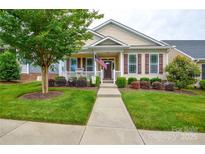 Charming single-Gathering home featuring a well-manicured lawn, walkway, shrubs, and inviting front porch at 11607 Meetinghouse Dr, Cornelius, NC 28031