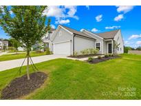 Charming home with a two-car garage, well-maintained lawn, and beautiful landscaping at 130 Slalom St, Statesville, NC 28677