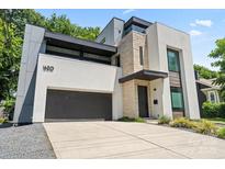 Stunning modern home showcasing a unique facade, a sleek garage door, and a well-manicured lawn at 1620 S Tryon St, Charlotte, NC 28203