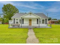 Charming single-story home features a cozy front porch and well-maintained lawn at 201 Robinson Rd, Gastonia, NC 28056