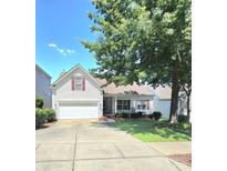 Charming white home with red shutters, a well-manicured lawn, and a welcoming two-car garage at 2226 Elendil Ln, Charlotte, NC 28269