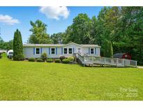 Charming single story home with blue shutters, a ramp, mature trees and a well manicured front yard at 231 Valley View Dr, Clover, SC 29710