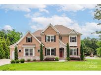 Attractive brick home featuring manicured landscaping, two stories, and a welcoming front entrance at 3009 Ocaso Ct, Matthews, NC 28104