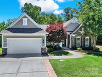 Charming home boasts manicured lawn, stone accents, and a two-car garage at 35115 Carnation Ln, Fort Mill, SC 29707