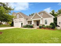 Inviting two-story home with a well-manicured lawn, landscaped garden beds, and a two-car garage at 3807 Blazeprince Dr, Charlotte, NC 28215