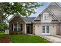 Charming two-story home with a brick facade, manicured lawn, and a welcoming front entrance at 4637 Willow Glen Rd, Harrisburg, NC 28075