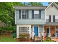 Charming two-story townhome with blue siding, shutters, and a bright blue front door at 6401 Windsor Gate Ln, Charlotte, NC 28215